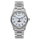 The image shows a BERNY wristwatch with a white dial and blue Arabic numerals. It features subdials for the date and day, along with a moon phase indicator. The watch is equipped with a silver metal bracelet.