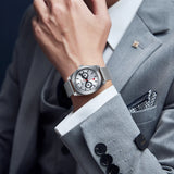 This image depicts a person wearing a stylish BERNY watch on their wrist, paired with a formal suit. The scene conveys a sophisticated and professional appearance, highlighting the watch as an elegant accessory.